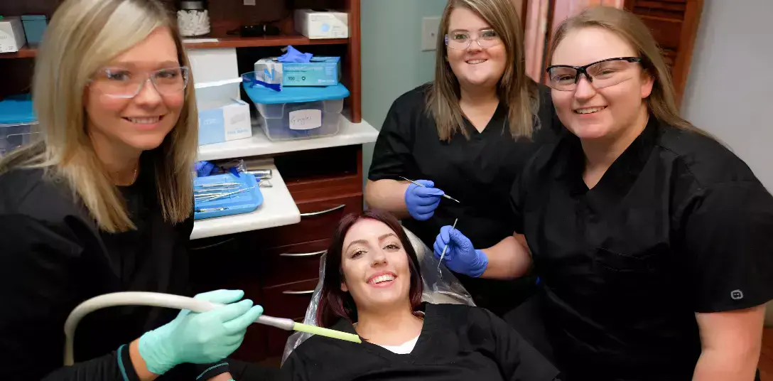 students practicing dental skills on each other